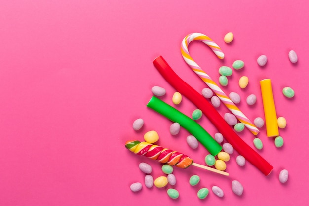 Colorful lollipops on a pink 