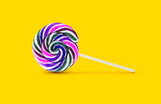 Colorful lollipops on yellow background