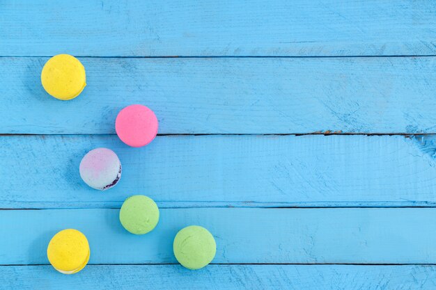 Colorful macaron cookies on blue wooden vintage table