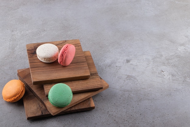 Colorful macarons dessert placed on a stone table .