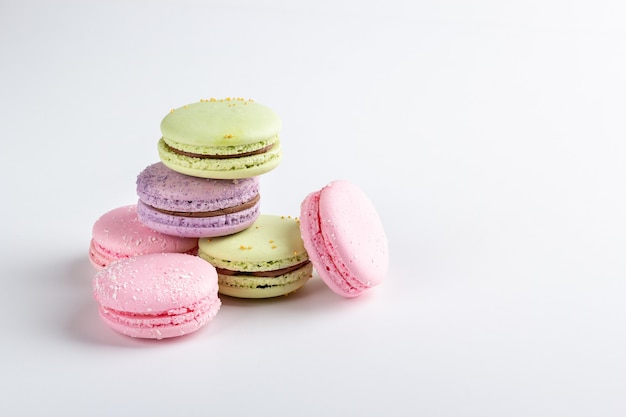 Colorful macarons isolated on white table