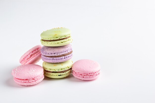 Colorful macarons isolated on white table