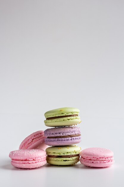 Premium Photo | Colorful macarons isolated on white table