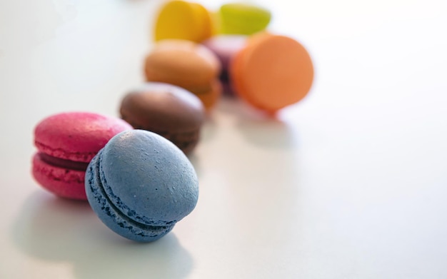 Colorful macarons on white background close up view