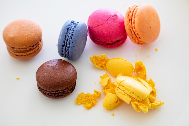 Colorful macarons on white background close up view