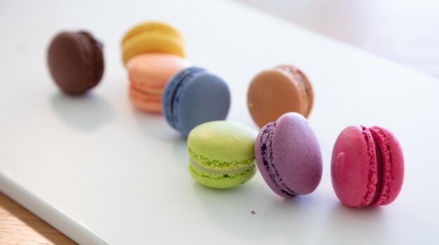 Colorful macarons on white background close up view
