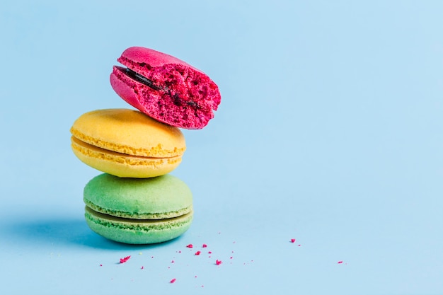 Colorful macaroons on a blue copyspace, close-up, Flatley with copyspace