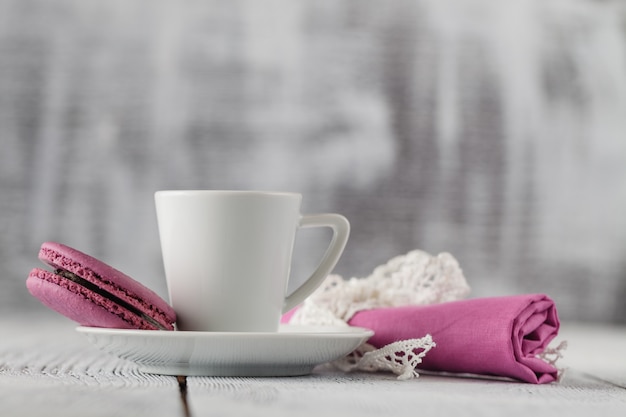 Colorful macaroons and coffee cup on shabby chic