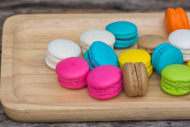 Colorful Macaroons in dish on wooden table