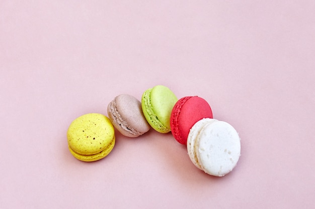 Colorful macaroons or macarons on the lemonade color background 