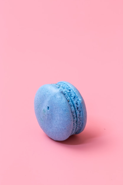 colorful macaroons in wood plate on pink background