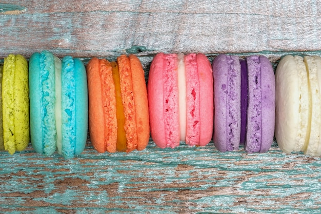 Colorful macaroons on wooden background