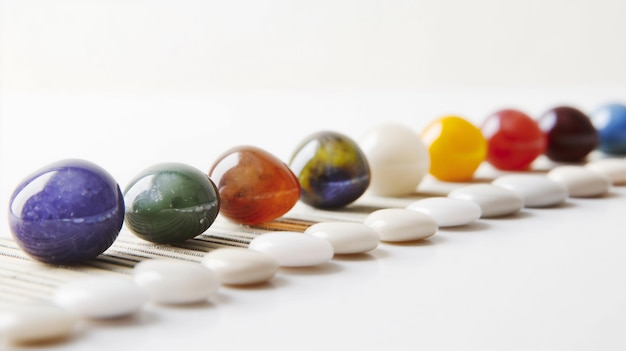 Colorful marbles arranged in a line on a striped surface displaying a variety of hues and reflection