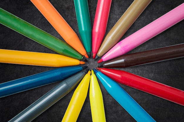 Colorful markers on the blackboard