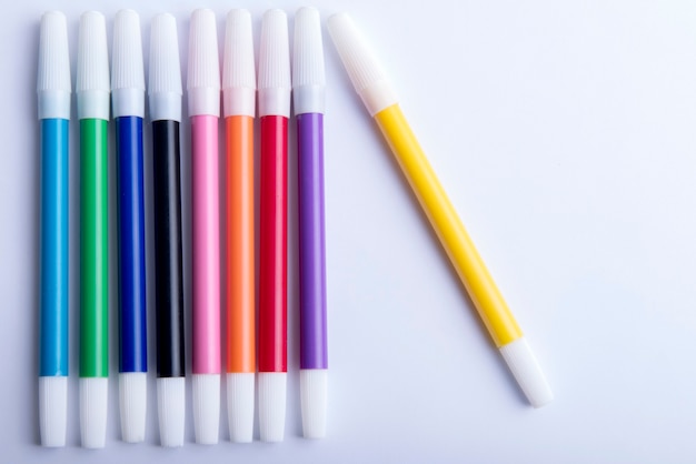 Colorful markers on white background