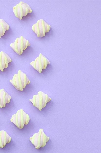 Colorful marshmallow laid out on violet paper