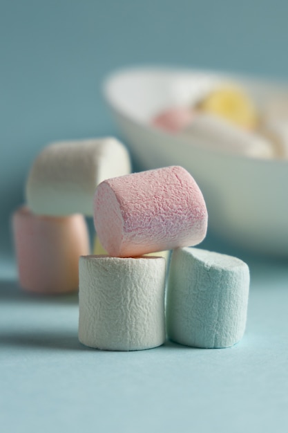 Colorful marshmallows on blue background