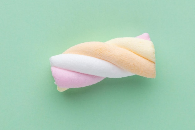 Colorful marshmallows on pastel background.