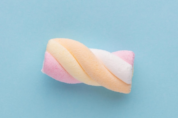 Colorful marshmallows on pastel background.