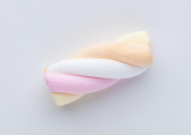 Colorful marshmallows on pastel background