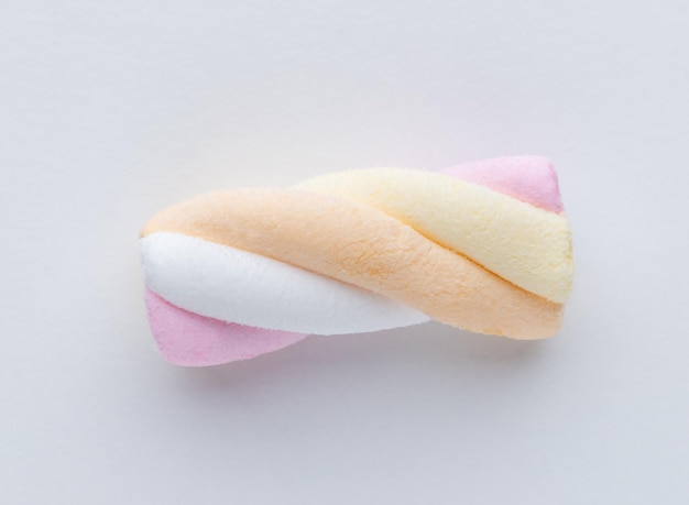 Colorful marshmallows on pastel background