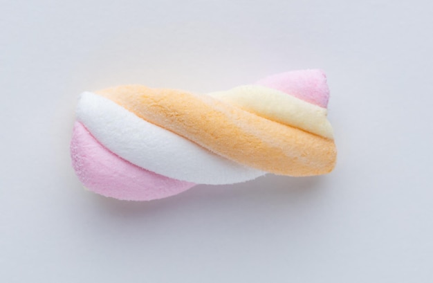 Colorful marshmallows on pastel background