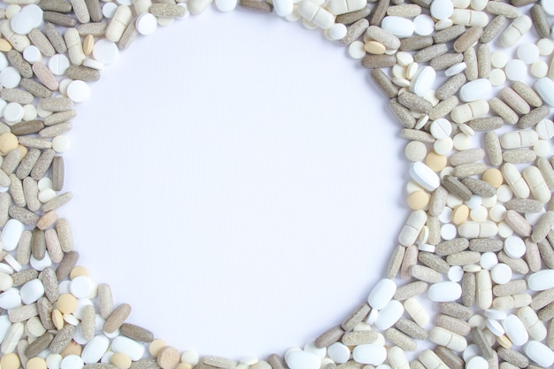 Colorful medical pills loose on a white background.