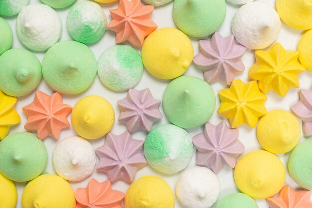 Colorful meringues isolated on a white background. Top view.