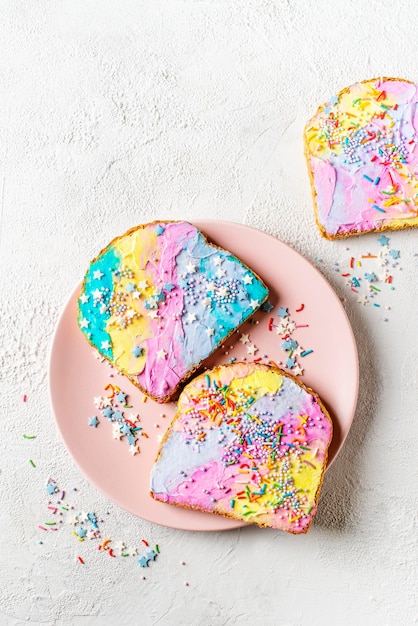 Colorful mermaid and unicorn toast with decoration on white background