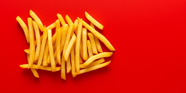 colorful minimalist crispy French fries top view isolated on red background generated ai