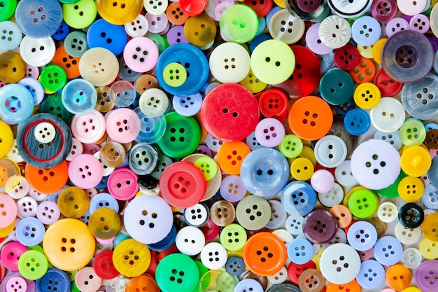 Colorful mixed sewing buttons background Top view