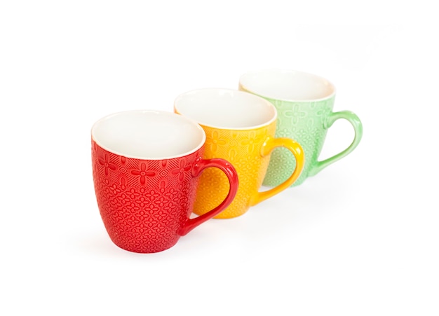 Colorful mugs isolated on white surface