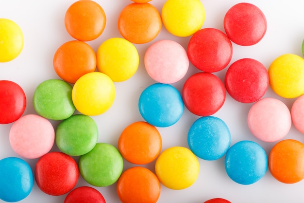 Colorful  multicolored chocolate candy dragees  on white background.