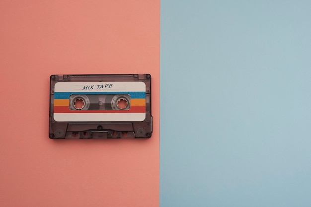 Colorful music cassette on pink and light blue background