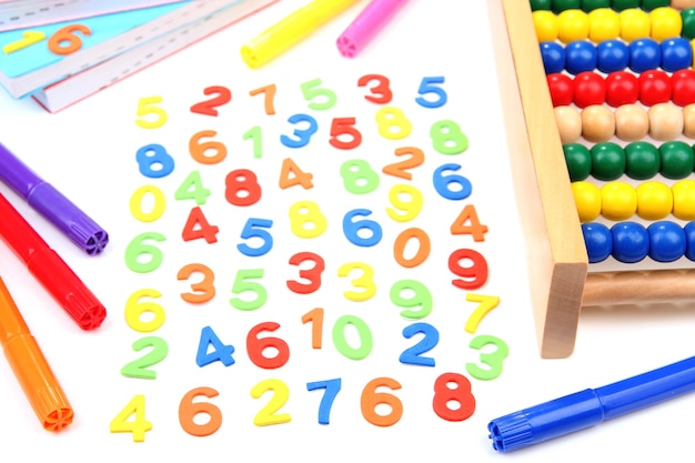 Photo colorful numbers abacus books and markers isolated on white