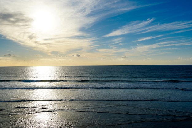 Colorful ocean beach sunset with deep clouded sky Beautiful cloud over the sea during sunset