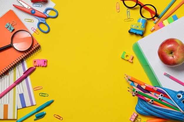 Colorful office and student supplies on yellow