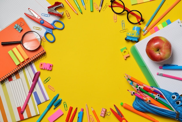 Photo colorful office and student supplies on yellow