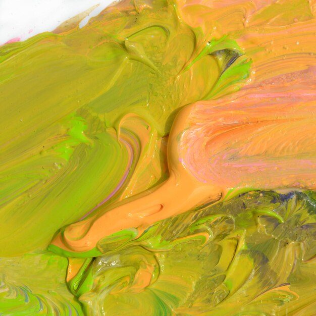 Colorful oil paint of different colors on a palette on white background