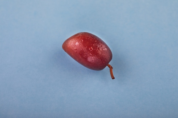 Colorful olive on a blue table, top view