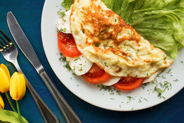 Colorful omelette breakfast with mozzarella and tomato