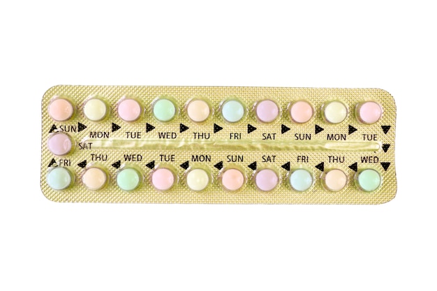 Colorful oral contraceptive pill in gold strip