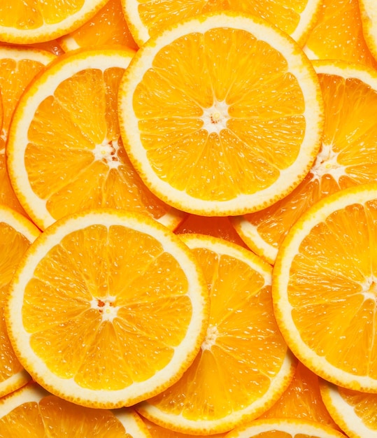 Colorful orange citrus fruit slices background top view