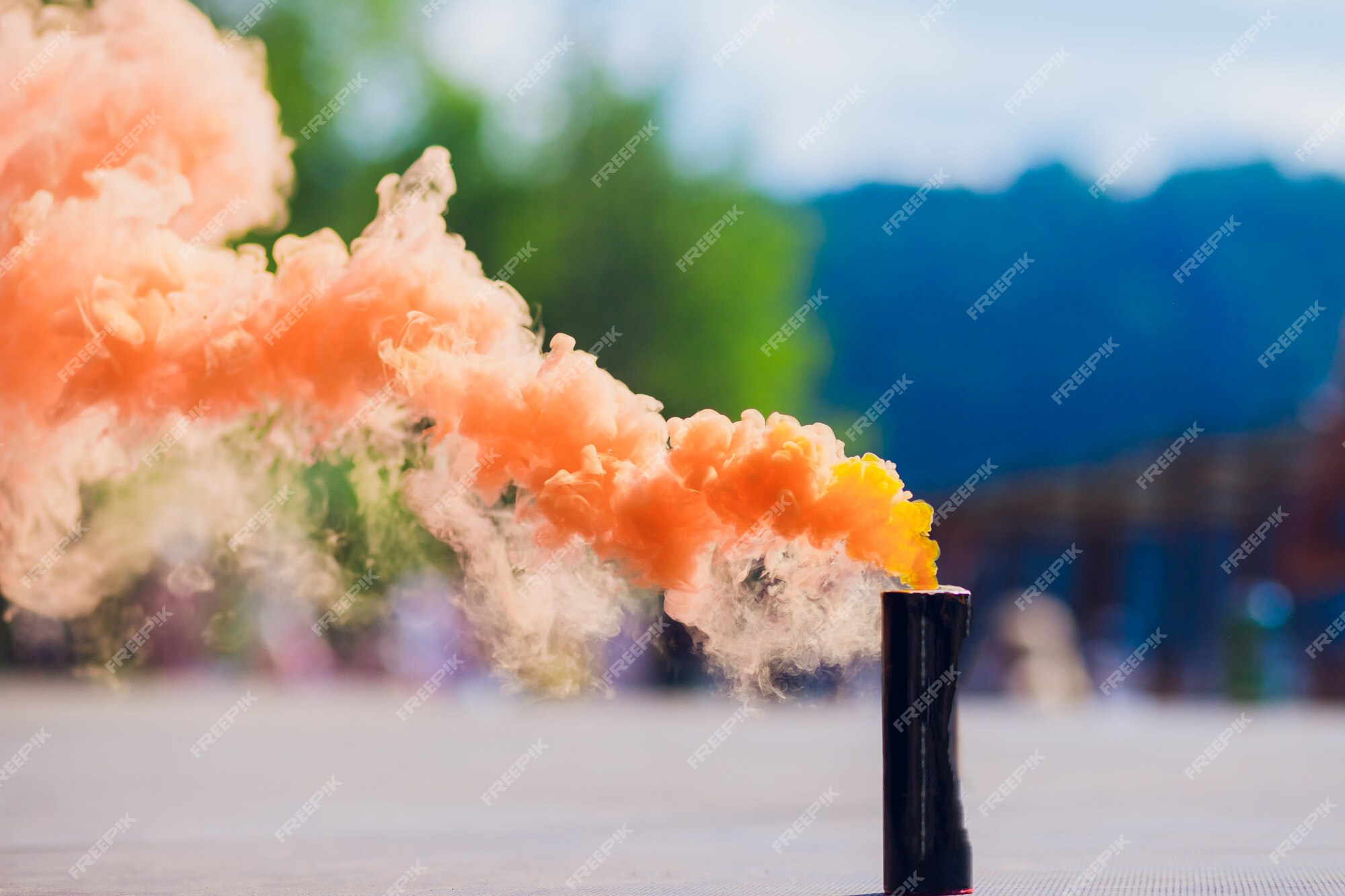 Premium Photo | Colorful orenge smoke bombs in action