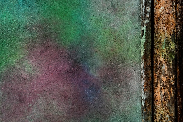 Colorful paint on gray concrete wall and brown wooden border