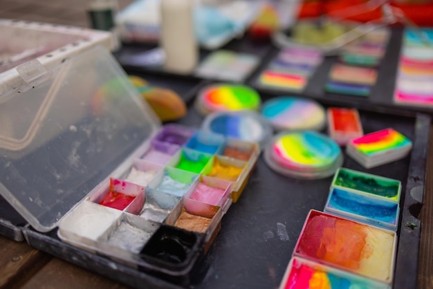 Colorful paint tubes on a table with paints used for face art