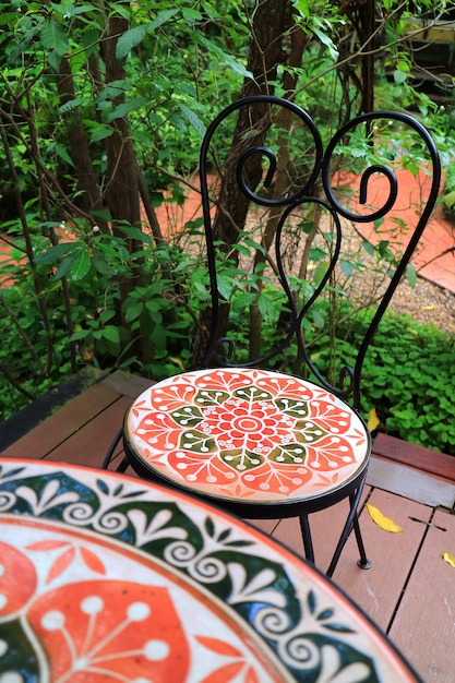 Colorful painted stone chair at the terrace green in garden, with selective focus