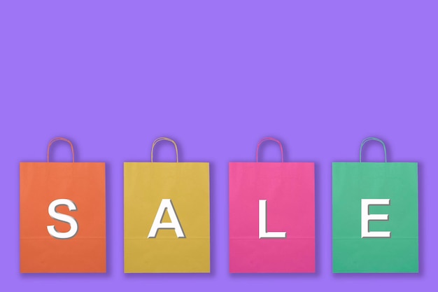 Colorful paper bags and the word Sales in lilac background