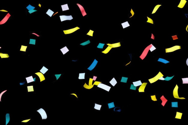 Photo colorful paper confetti on black background