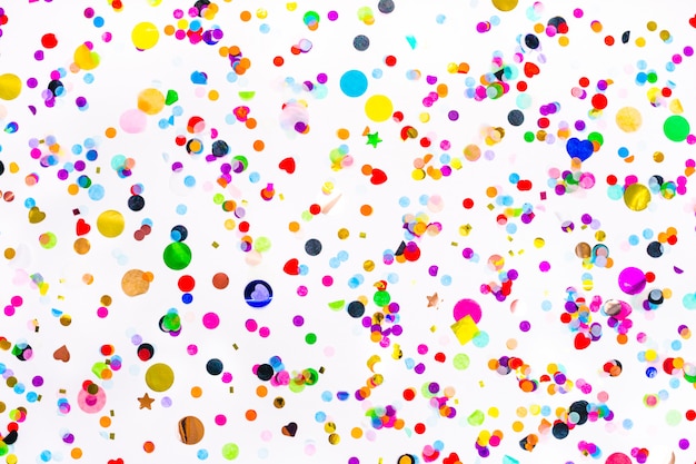 colorful paper and foil confetti isolated on white